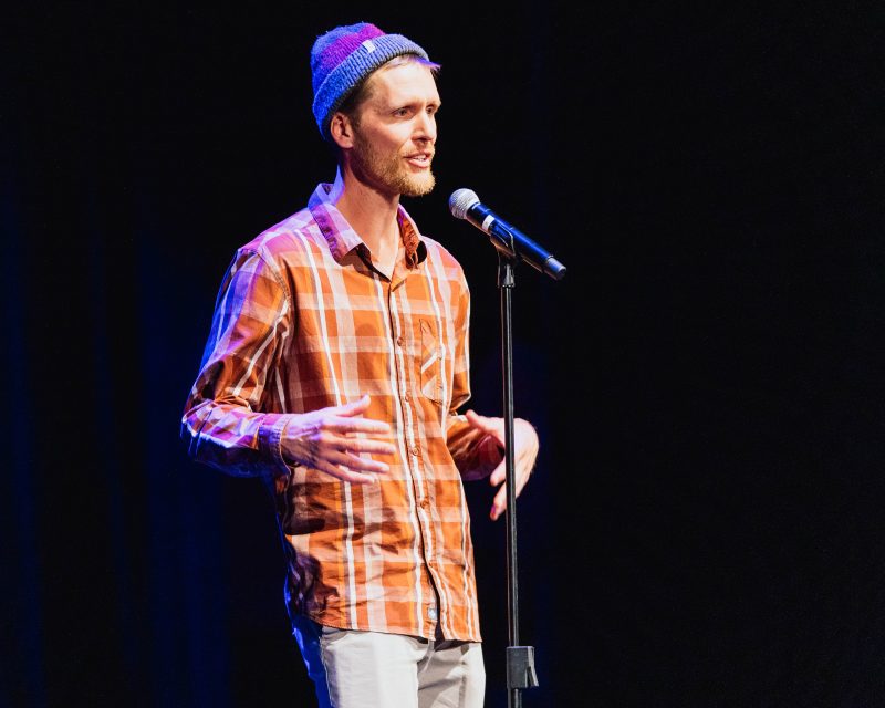 Ben Catton is a tall man in Chile who tries to connect with a Deaf grandmother, culminating in the around a parakeet cage . Ben calls his story “Periquitos”.