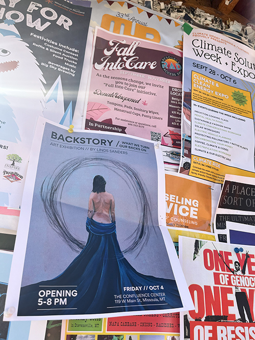 The image is of a group of posters with a focus on Linds Sanders' art exhibition opening. That image is of the back of a woman wearing a flowing dress.
