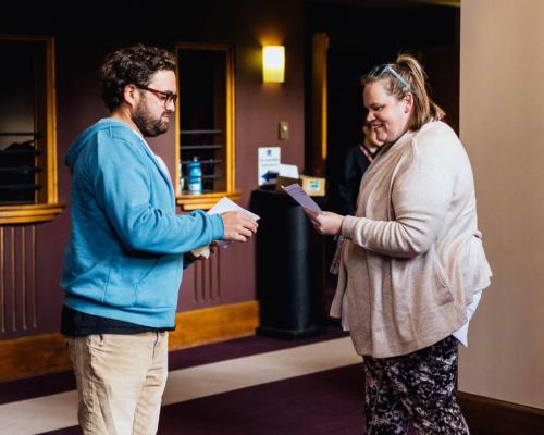 Volunteer Ryder Sutton welcomes a guest and encourages them to share their "Lost in Translation" story anonymously as part of audience participation.Donal Lakatua